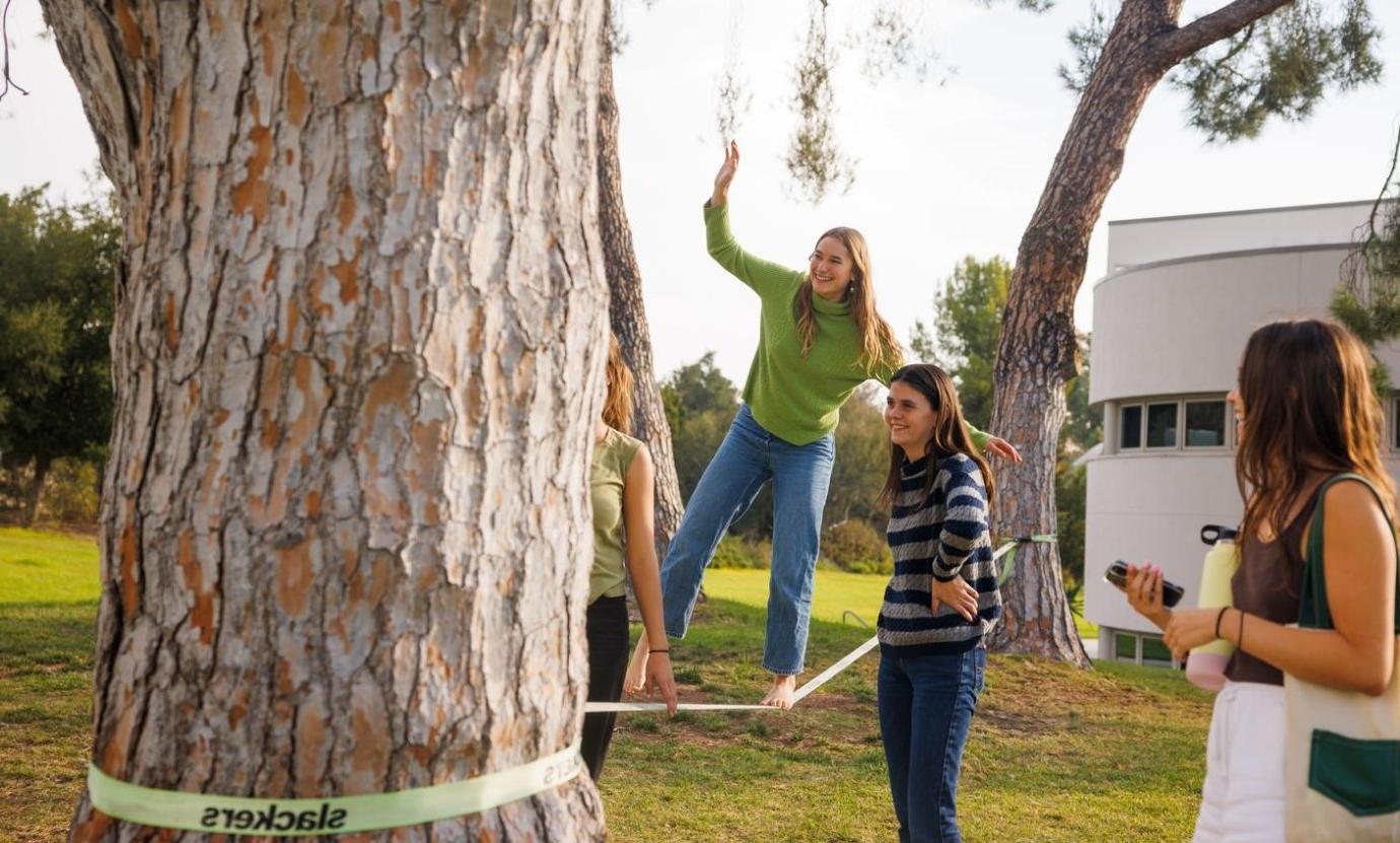 A Pitzer student balances on the slackline at the Mounds